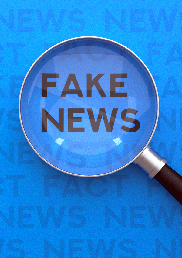 eine Lupe über dem Text Fake News